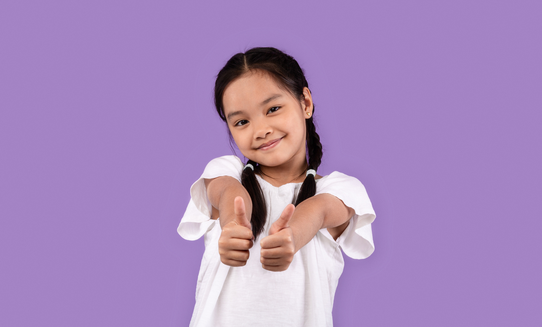 Japanese Kid Girl Gesturing Thumbs Up Standing Over Purple Background